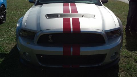 2007 Ford Mustang - Front view of a silver 2007 Ford Mustang Shelby GT500 with red racing stripes.