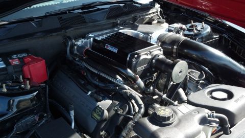 2007 Ford Mustang - Close-up of a supercharged V8 engine, likely from a Ford Mustang, with 'Ford Racing' branding visible.