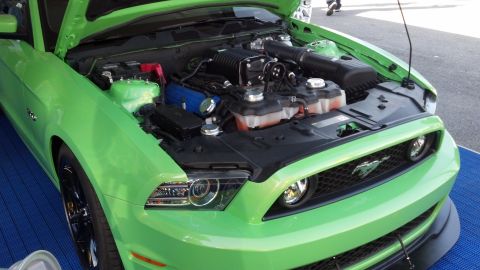 2007 Ford Mustang - A bright green Ford Mustang displays its supercharged engine with the hood open.