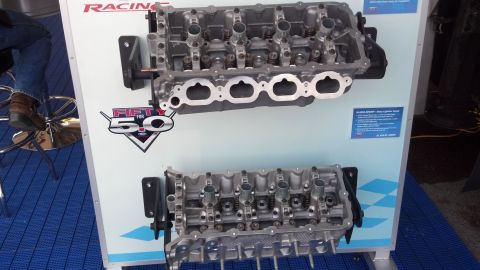 2007 Ford Mustang - Display of engine cylinder heads, possibly for a Ford vehicle, at a racing event.