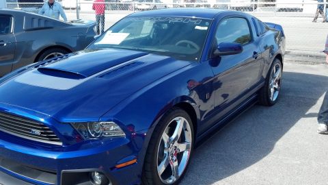 2007 Ford Mustang - A blue Roush Mustang is parked next to another Mustang at an outdoor event.