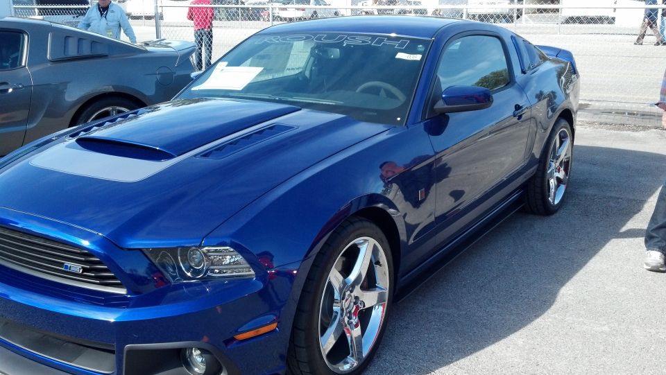 Blue Roush Mustang with hood scoop and chrome wheels