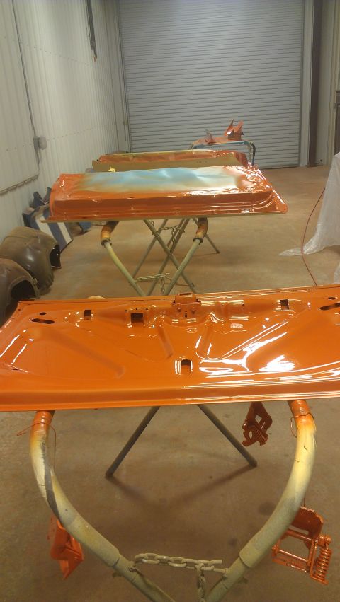 1973 Chevrolet Camaro - Car doors are being prepped and painted in an orange finish.