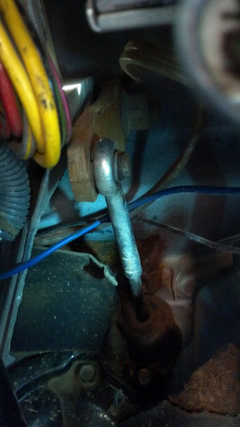 1986 Ford Bronco - This photo shows a close-up view of a vehicle's clutch linkage system, including various wires and a blue cable.