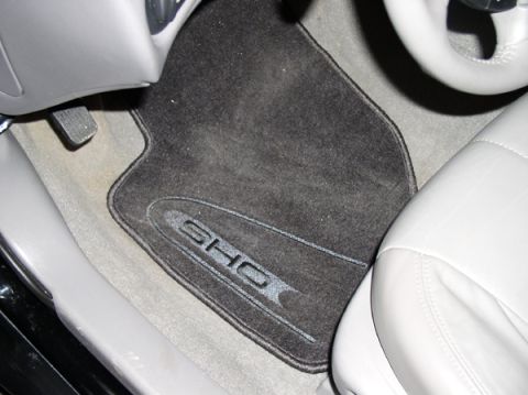 1998 Ford Taurus - The floor mat displays the SHO logo, indicating a specific trim level, but the vehicle year is not discernible from this interior shot.
