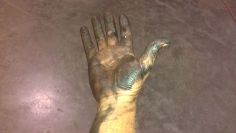 1973 Chevrolet Camaro - A greasy hand is shown against a textured background, with a website watermark at the bottom right.