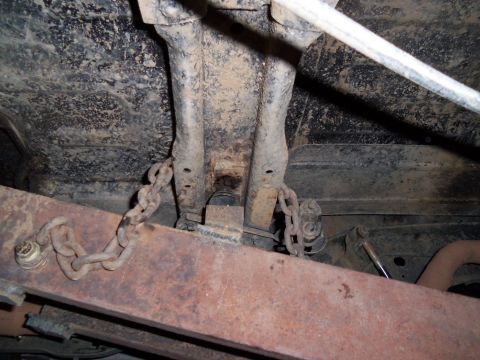 1989 Ford Bronco - Underbody view showing suspension components and chains, likely from a truck or SUV.