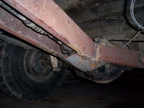 1989 Ford Bronco - Close-up view of the undercarriage, focusing on the frame and suspension elements of a vehicle.