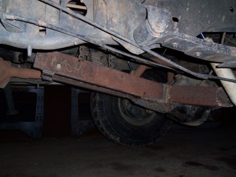 1989 Ford Bronco - Close-up view of the undercarriage, focusing on the rear suspension system.