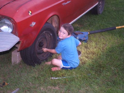1966 Ford Ranchero - Boy helps with car maintenance on a 1966 Ford Ranchero.