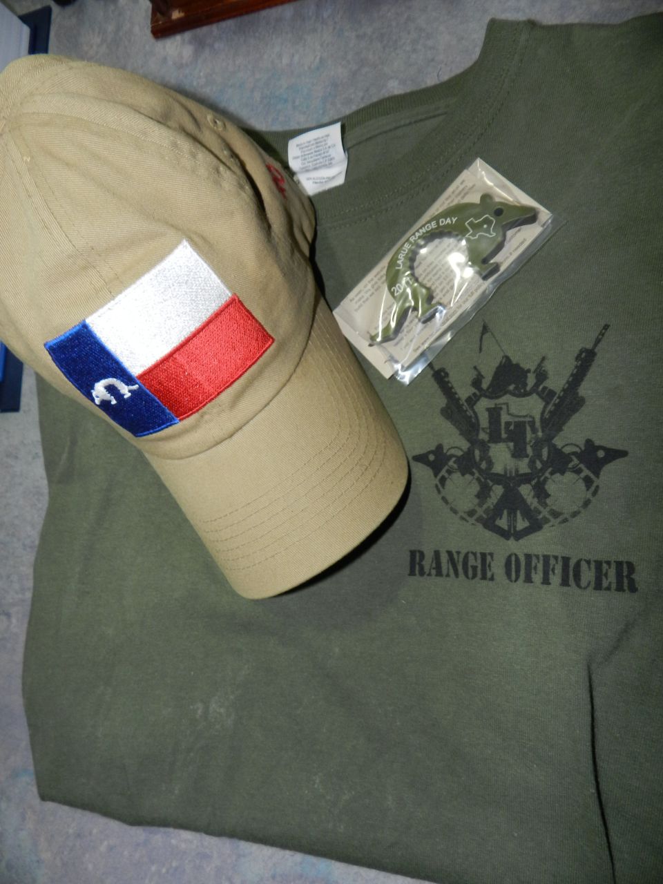 Tan cap with Texas flag patch and green t-shirt with