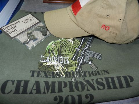 1996 Ford Bronco - Merchandise related to LaRue Tactical and a 2012 shooting competition is laid out with a beverage entry tool from 2011.