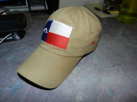 1996 Ford Bronco - A tan baseball cap with a Texas flag patch is displayed on a desk.