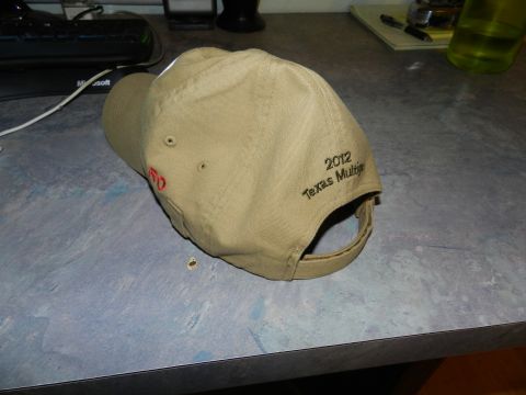 1996 Ford Bronco - A tan baseball cap with a red logo and embroidered text indicating '2012 Texas Multi' is shown on a desk.
