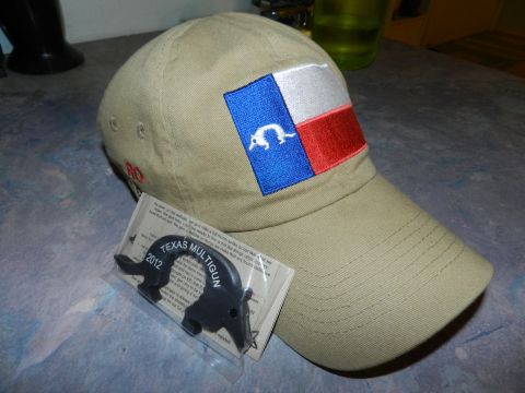 1996 Ford Bronco - Baseball cap with Texas flag patch and a Texas Multigun 2012 keychain are displayed on a table.
