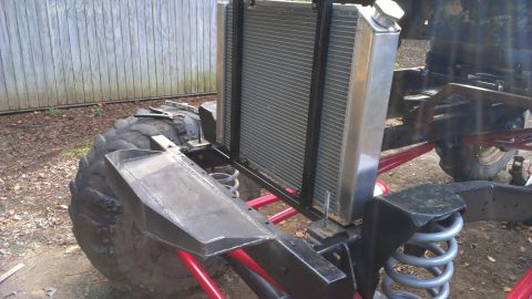 1978 Ford Bronco - Custom off-road vehicle under construction, a large radiator and heavy-duty suspension components.