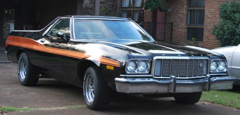 1975 Ford Ranchero - Front 3/4 view of a black 1975 Ford Ranchero with an orange stripe.