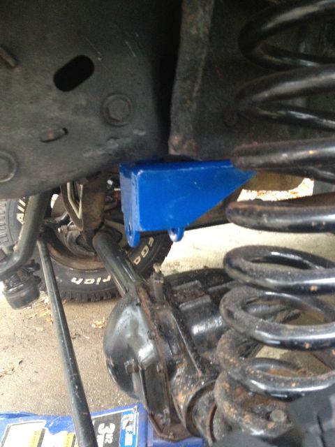 1996 Ford F-150 - Close-up of a blue suspension bracket installed on a vehicle's axle, part of a solid axle swap.
