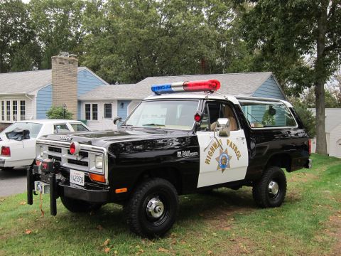 1987 Dodge 1500 - A black and white Dodge Ramcharger, marked as Highway Patrol, sits on a grassy lawn.