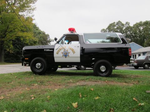 1987 Dodge 1500 - This 1987 Dodge Ramcharger police SUV features a black and white paint scheme and "HIGHWAY PATROL" markings on the door.