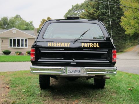 1987 Dodge 1500 - This black SUV, marked "HIGHWAY PATROL", is seen from the rear with a California license plate.