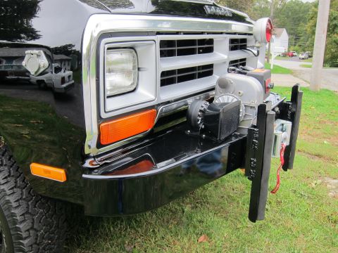 1987 Dodge 1500 - Front view of a black 1987 Dodge 1500 pickup truck a chrome grille and a winch mounted on the bumper.