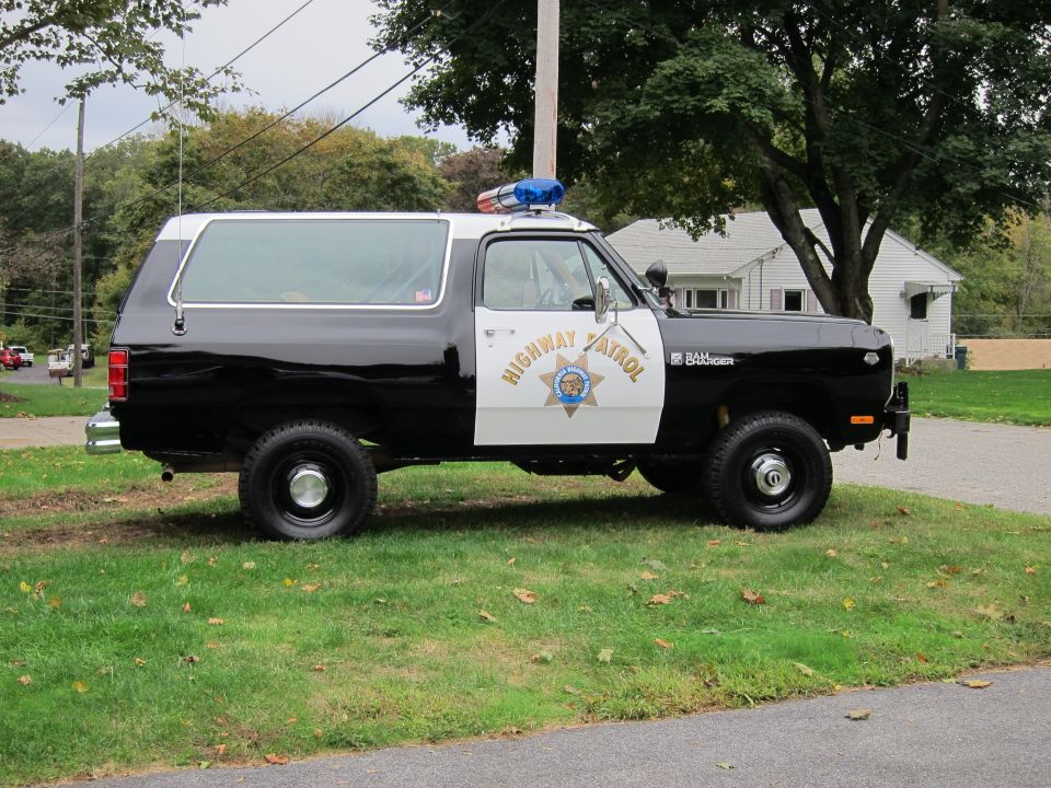 Black and white Dodge Ramcharger police vehicle with "Highway Patrol" text and a light bar