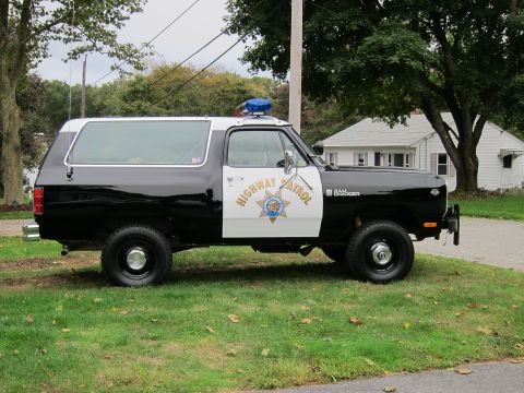 1987 Dodge 1500 - This 1987 Dodge Ramcharger, marked as "HIGHWAY PATROL", is seen from the side, its distinctive two-tone paint scheme and emergency light ba…