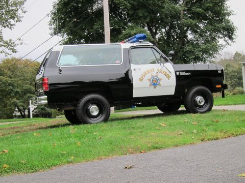 1987 Dodge 1500 - This Dodge Ramcharger police vehicle features a two-tone paint scheme and "HIGHWAY PATROL" markings on the door.