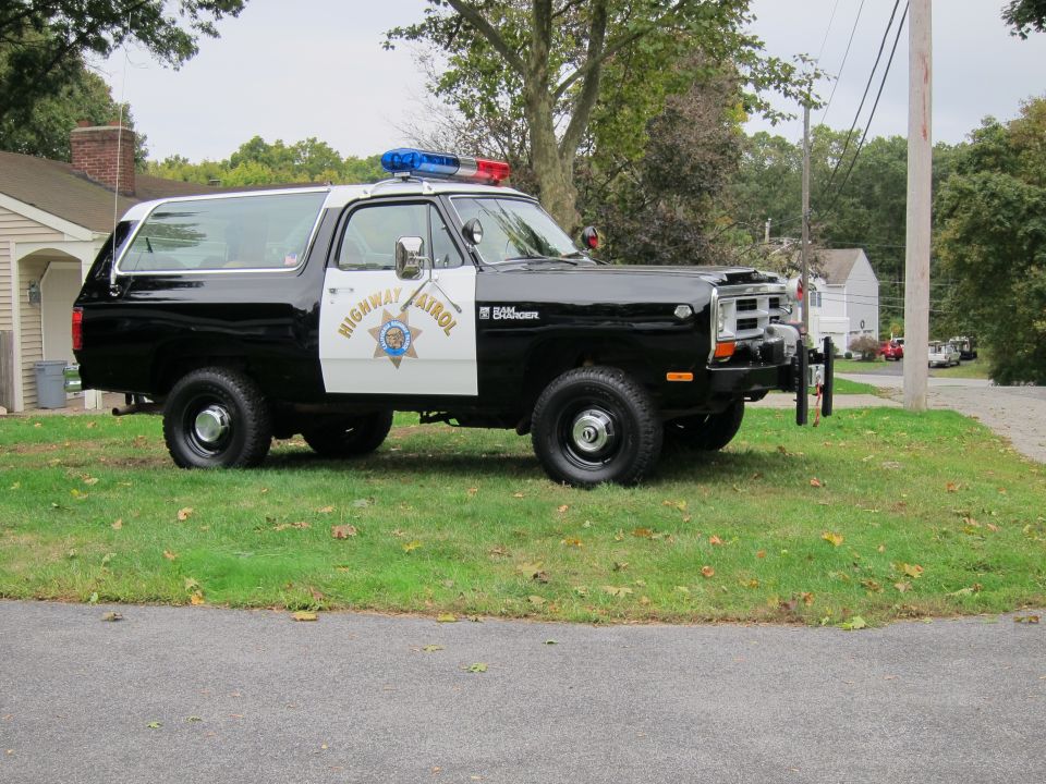 Black and white Dodge Ramcharger with "Highway Patrol" on the door and light bar on top