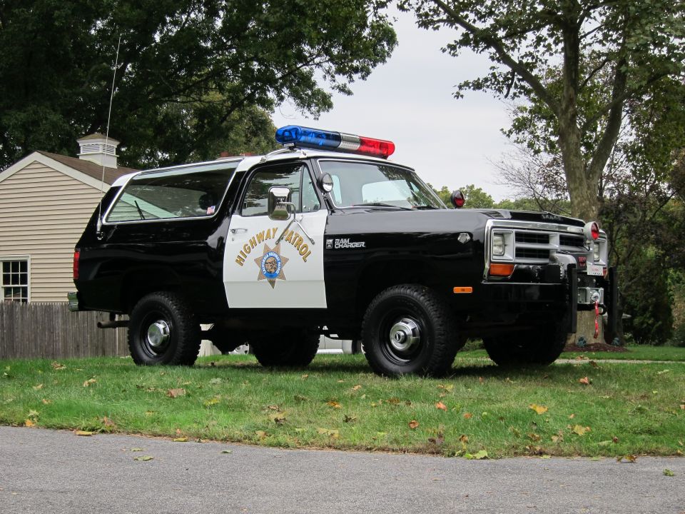 Black and white Dodge Ramcharger SUV with "Highway Patrol" on the door and a light bar on top