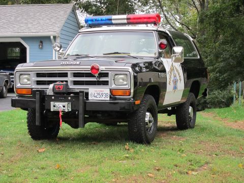 1987 Dodge 1500 - This 1987 Dodge Ramcharger police SUV features a light bar, siren, and a front-mounted winch, ready for duty.