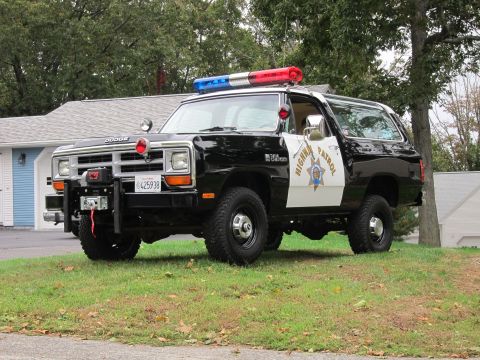 1987 Dodge 1500 - A 1987 Dodge 1500 Ramcharger, marked as Highway Patrol, is parked on a grassy area in front of a house.