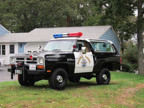 1987 Dodge 1500 - This black and white Dodge Ramcharger is equipped as a police vehicle with a light bar and siren.