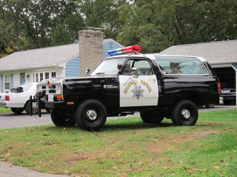 1987 Dodge 1500 - This Dodge Ramcharger is outfitted as a police vehicle, complete with a light bar and official markings.