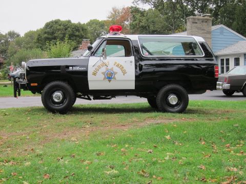 1987 Dodge 1500 - This 1987 Dodge Ramcharger police SUV features a black and white paint scheme and 'Highway Patrol' markings on the door.