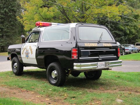 1987 Dodge 1500 - This 1987 Dodge Ramcharger served as a highway patrol vehicle, identifiable by its distinctive black and white livery and emergency lights.