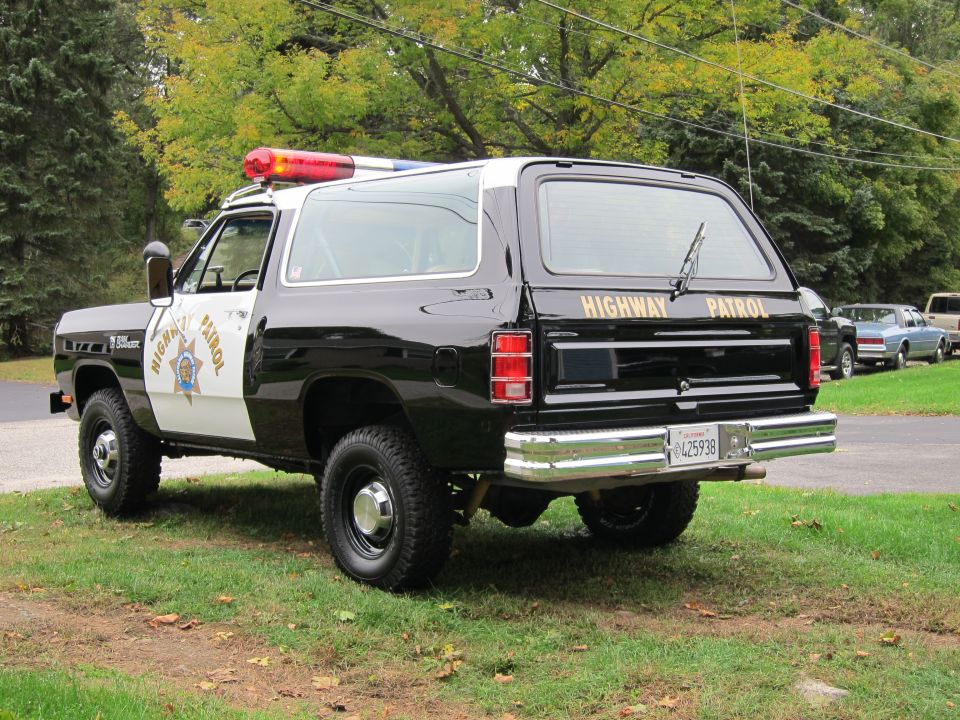 Rear view of a black and white 1987 Dodge Ramcharger highway patrol SUV with "HIGHWAY PATROL" text