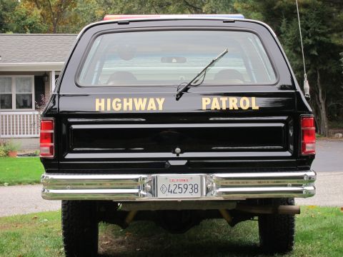 1987 Dodge 1500 - Rear view of a black SUV with 'HIGHWAY PATROL' lettering and a California license plate.