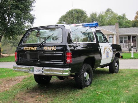 1987 Dodge 1500 - This highway patrol SUV features "HIGHWAY PATROL" text on the tailgate and a two-tone black and white paint scheme.