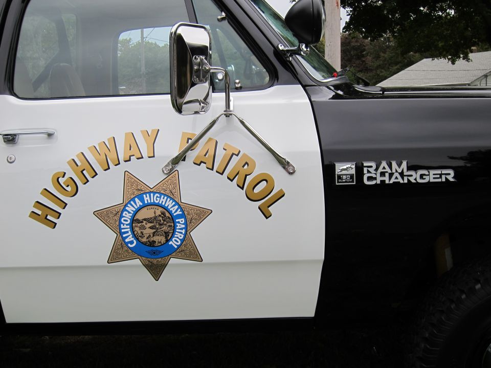 Side view of a 1987 Dodge 1500 Ram Charger with California Highway Patrol markings on the door