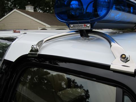 1987 Dodge 1500 - Close-up of a vehicle's roof, showing a light bar and chrome accents.