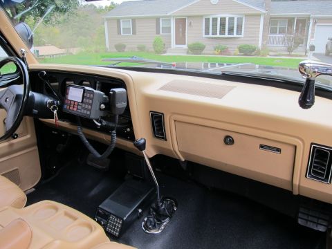 1987 Dodge 1500 - Interior view of a 1987 Dodge 1500 pickup truck, a tan dashboard and aftermarket radio equipment.