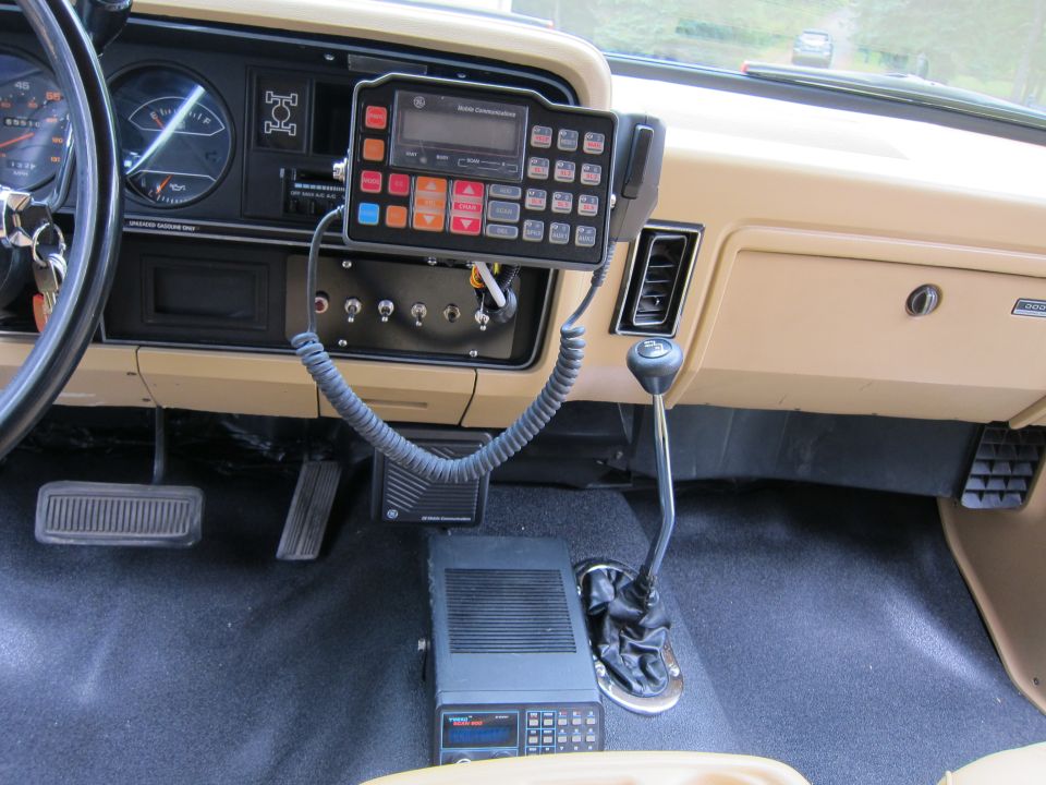 1987 Dodge 1500 interior showing dashboard, steering wheel, CB radio, and floor shifter