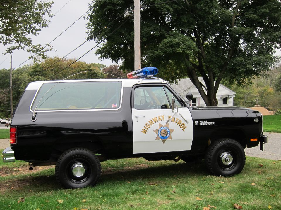 Black and white Dodge Ramcharger police SUV with "Highway Patrol" text and a light bar