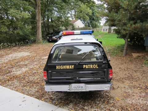 1987 Dodge 1500 - This highway patrol truck has "HIGHWAY PATROL" text on its tailgate and a light bar on the roof.