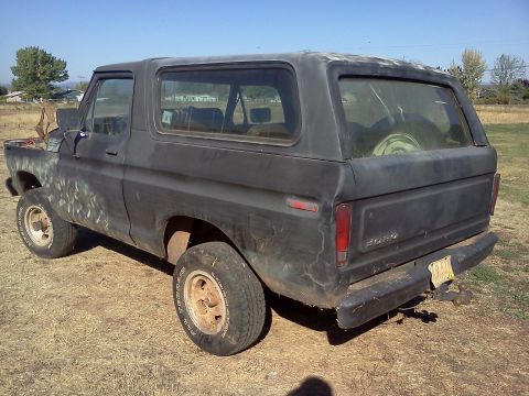 1978 Ford Bronco - This 1978 Ford Bronco is shown from a rear-three-quarter perspective, revealing its weathered condition.