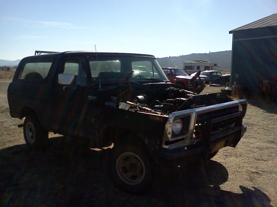 Black 1978 Ford Bronco with hood open, parked outdoors