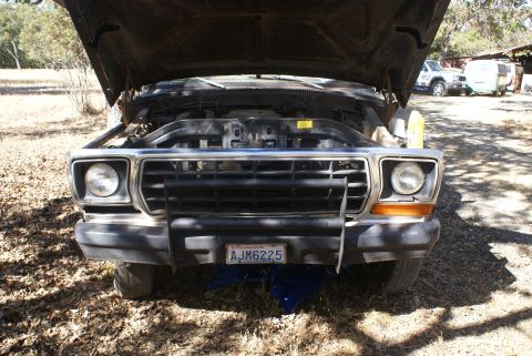 1978 Ford Bronco - Front view of a 1978 Ford Bronco with its hood open, revealing the engine compartment. The license plate reads AJM6225.