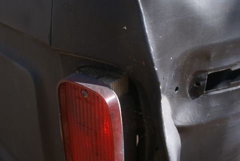 1978 Ford Bronco - Close-up of a vehicle's rear corner, showing a red taillight and surrounding bodywork.